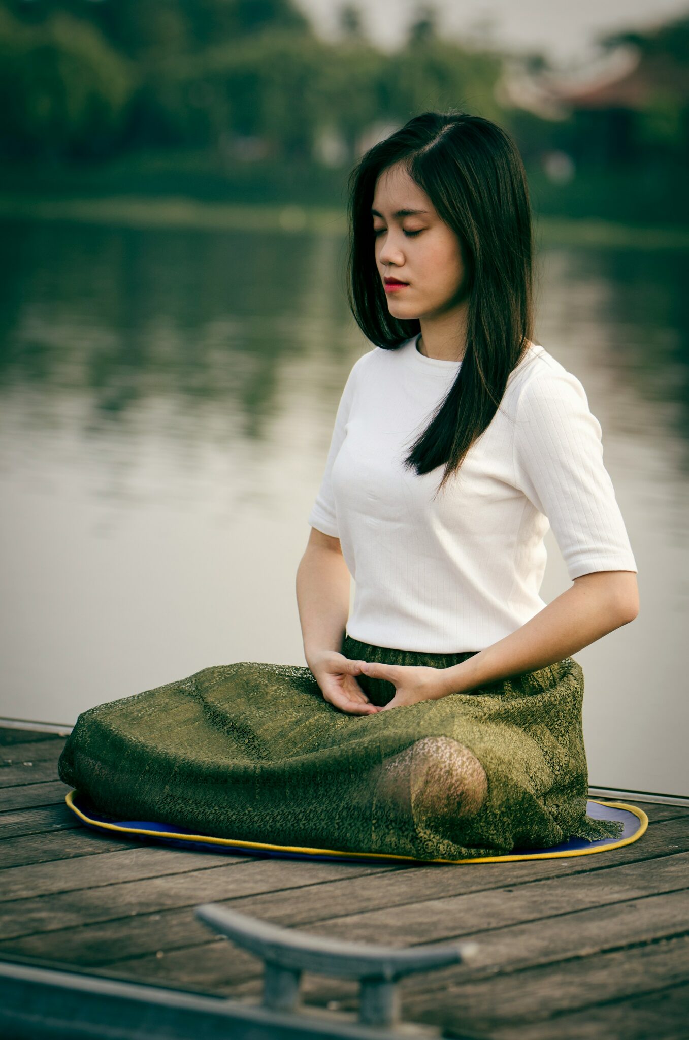 Meditating Woman Close to a Lake