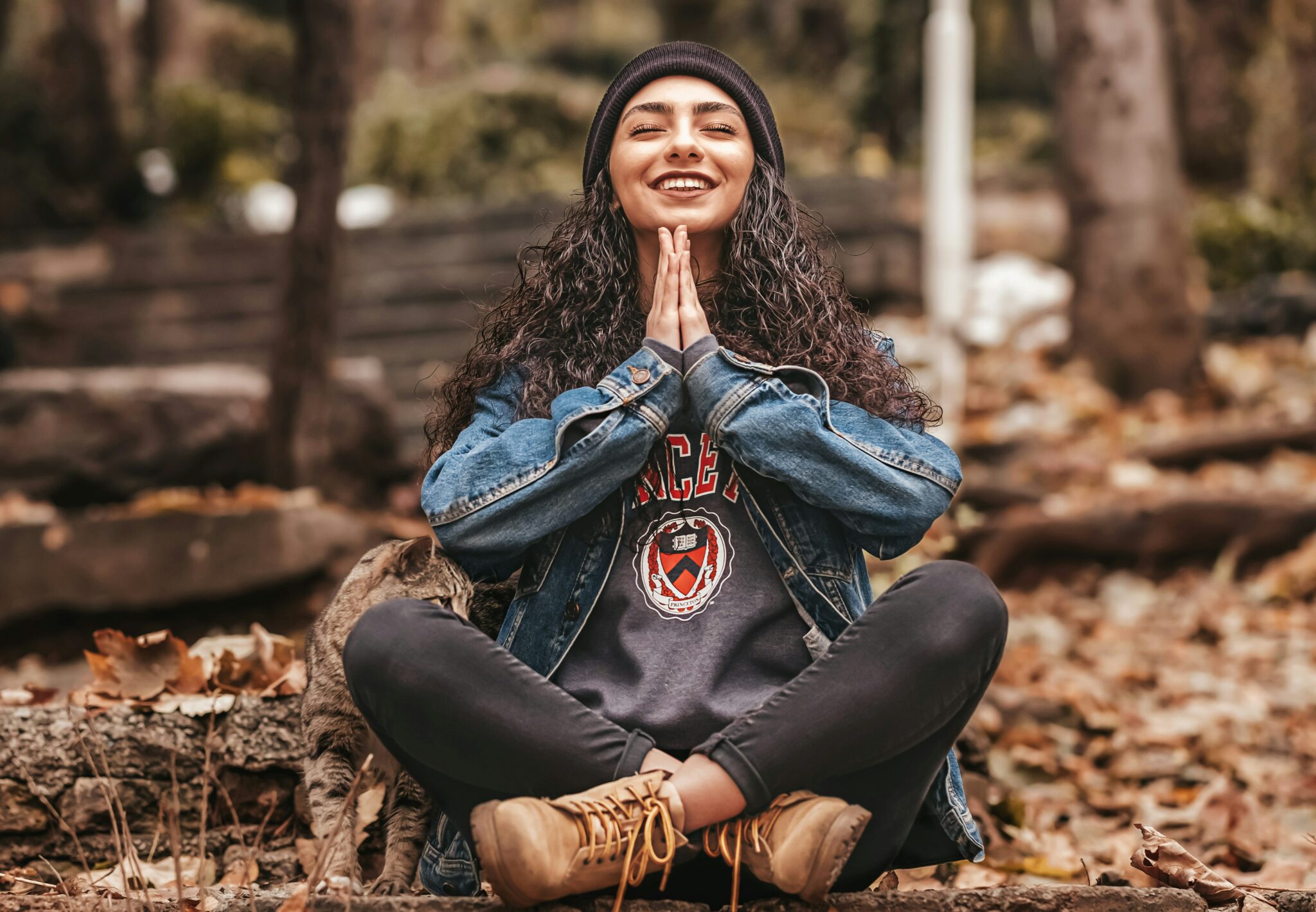 Happy Woman Meditating in a Forest in Autumn